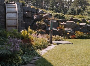 Boulder retaining wall with water mill