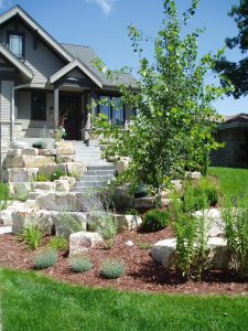 Stone entry stairway and boulder retaining wall
