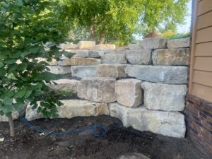 Boulder retaining wall Prescott Wi back yard